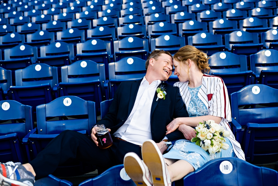 A bride and groom at a Phillies game at Citizens Bank Park for their wedding reception.
